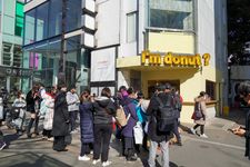  A large line waiting for Im Donut, popular Japanese donut shop known for its fluffy, or raw donuts.