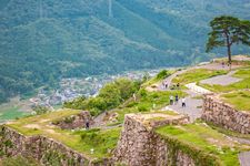 Landscape photo of tourists and local visitors walking around Takeda Castle Ruins located in Hyogo Prefectures Asago City in Japan, which is a famous and popular side trip from nearby Himeji.