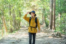 Ilustrasi orang Jepang memakai jaket dan topi sedang naik gunung.