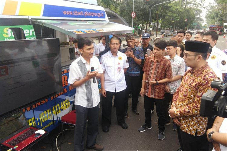 Gubernur Jawa Barat Ridwan Kamil saat melakukan simulasi program pelaporan pungli digital di Jalan Diponegoro, Jumat (5/7/2019).