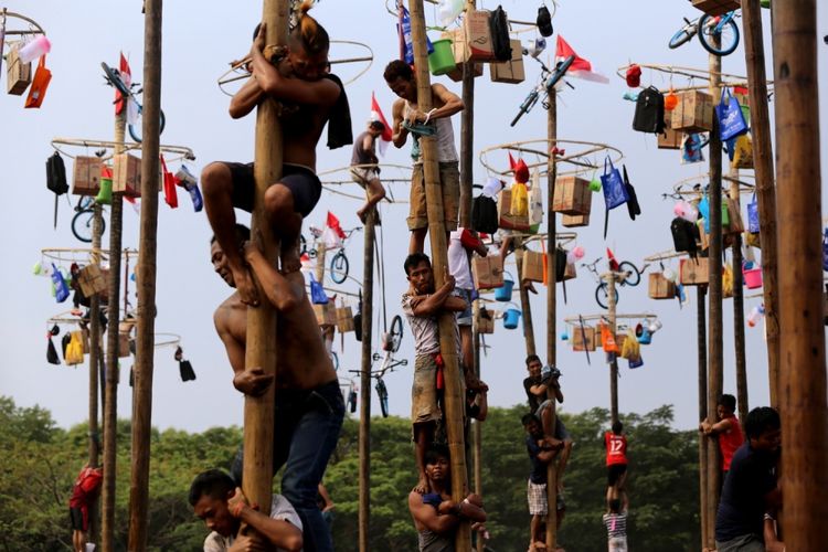 Sejumlah warga mengikuti lomba panjat pinang kolosal di Pantai Carnaval, Taman Impian Jaya Ancol, Jakarta Utara, Kamis (17/8/2017). Dalam perlombaan panjat pinang kolosal itu disiapkan 172 batang pohon pinang dengan aneka macam hadiah sekaligus memeriahkan perayaan HUT ke-72 Kemerdekaan Republik Indonesia.