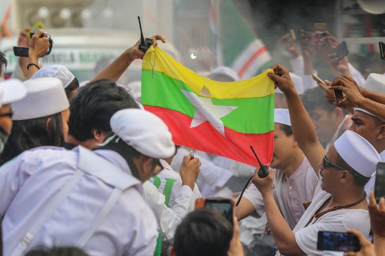Massa membakar bendera Myanmar saat aksi unjuk rasa di depan Kedutaan Besar (Kedubes) Myanmar di Jalan Agus Salim, Menteng, Jakarta Pusat, Rabu (6/9/2017). Massa mengecam tindakan kekerasan terhadap umat Islam Rohingya dan meminta Pemerintahan Republik Indonesia memutus hubungan diplomasi serta menurunkan bendera Myanmar di Kantor Kedutaaan Besar Myanmar.