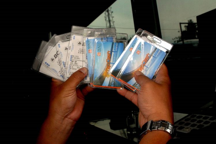 Petugas memperlihatkan kartu uang elektronik yang dibagikan secara cuma-cuma di gerbang pintu tol Jagorawi Citeureup, Kabupaten Bogor, Jawa Barat, Senin (16/10/2017). Sebanyak 1,5 juta uang elektronik akan dibagikan gratis mulai 16 Oktober hingga 31 Oktober 2017. Masyarakat cukup membayar saldonya saja. Pembebasan biaya kartu ini bertujuan untuk meningkatkan penetrasi pembayaran nontunai di gerbang tol sampai 100 persen. ANTARA FOTO/Yulius Satria Wijaya/kye/17.