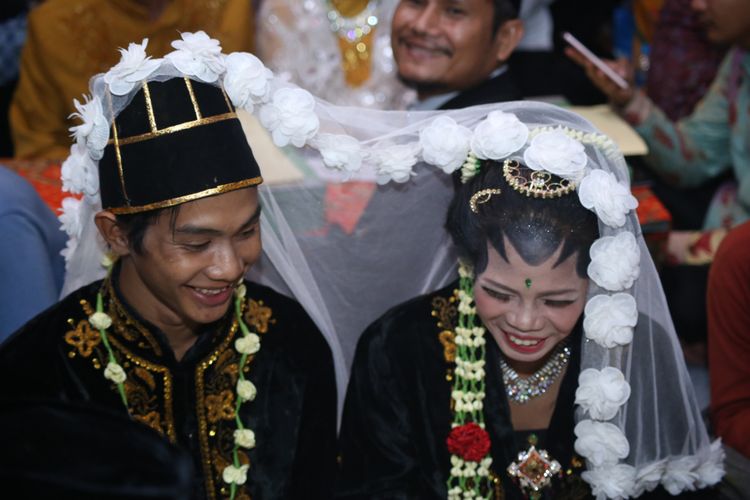 Sejumlah Pasangan pengantin mengikuti nikah massal di jalan MH Thamrin, Jakarta Pusat, Minggu (31/12/2017). Nikah massal yang diadakan oleh pemerintah DKI Jakarta ini diikuti sebanyak 437 pasangan pengantin dari berbagai usia.
