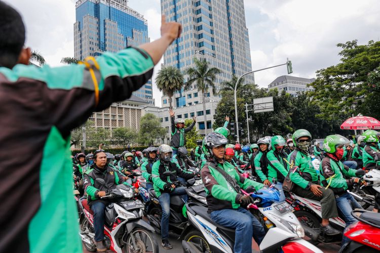 Pengemudi ojek online melakukan aksi unjuk rasa di depan Istana Negara, Jakarta Pusat, Selasa (27/3). Massa dari pengemudi ojek online menuntut pemerintah membantu untuk berdiskusi dengan perusahaan transportasi online agar merasionalkan tarif.