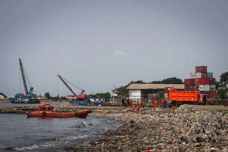 Sejumlah petugas membersihkan hamparan sampah di pesisir Cilincing, Jakarta Utara, Rabu (28/3/2018). Sampah yang mayoritas berasal dari limbah domestik rumah tangga itu diperkirakan mencapai panjang kurang lebih 500 meter, mulai dari KBN Marunda hingga permukiman warga.