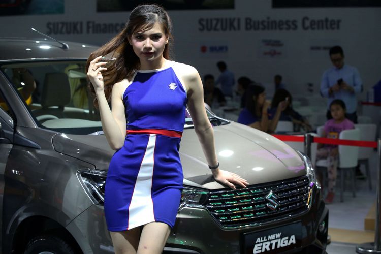 Sales Promotion Girl berpose di samping mobil yang dipamerkan di Indonesia International Motor Show 2018 di JI Expo Kemayoran, Jakarta, Jumat (20/4/2018). Pameran otomotif terbesar di Indonesia ini akan berlangsung hingga 29 April 2018 mendatang.