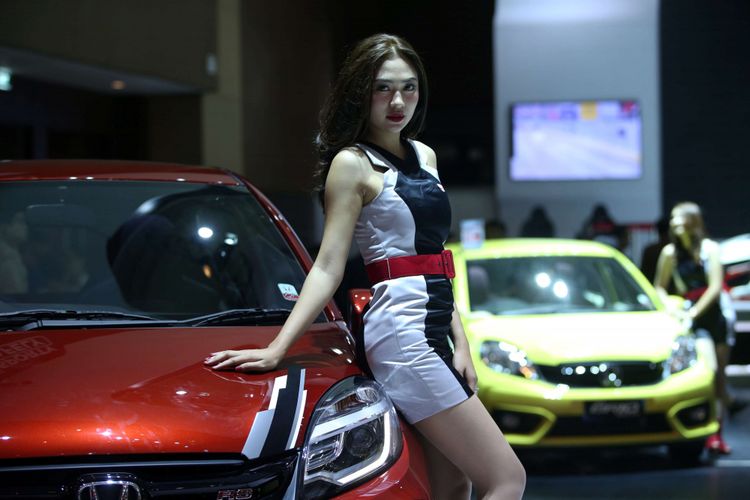Sales Promotion Girl berpose di samping mobil yang dipamerkan di Indonesia International Motor Show 2018 di JI Expo Kemayoran, Jakarta, Jumat (20/4/2018). Pameran otomotif terbesar di Indonesia ini akan berlangsung hingga 29 April 2018 mendatang.