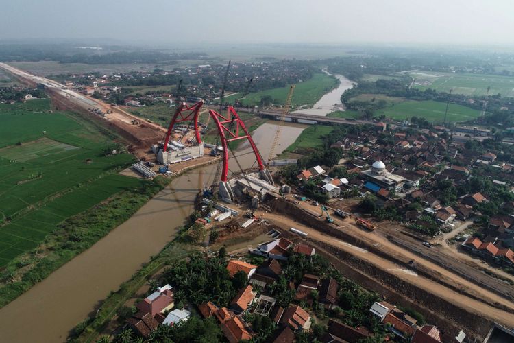 Foto udara pembangunan jembatan Kali Kuto di Proyek ruas Tol Batang-Semarang, Jawa Tengah, Minggu (3/6/2018). Jembatan Kali Kuto ditargetkan untuk digunakan pada H-2 lebaran dan merupakan jembatan pelengkung baja pertama di Indonesia yang perakitannya dilakukan di lokasi pekerjaan.