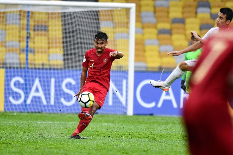 Bek Timnas U-16 Indonesia, Komang Teguh, mengamankan daerahnya dari serangan para pemain Iran pada laga Grup A Piala Asia U-16 2018, 21 September 2018. 