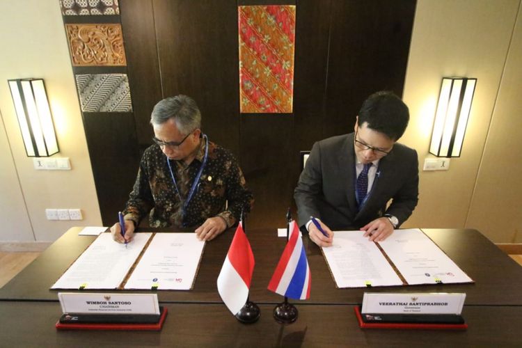 Ketua Dewan Komisioner Otoritas Jasa Keuangan Wimbih Santoso bersama Gubernur Bank of Thailand  Veerathai Santiprabhob, meneken kerja sama, Jumat (12/10/2018)