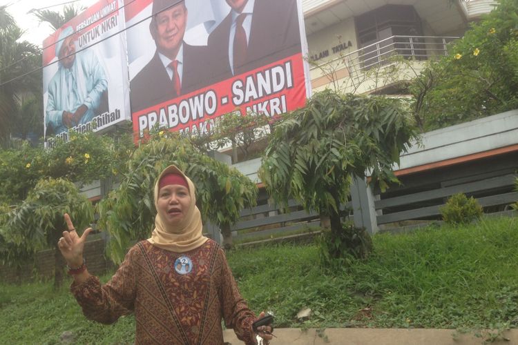 Habibah, salah satu relawan pasangan calon presiden nomor urut 2 memasang baliho Prabowo-Sandiaga di depan rumahnya, di Jalan Sutomo Semarang, Jumat (21/12/2018)