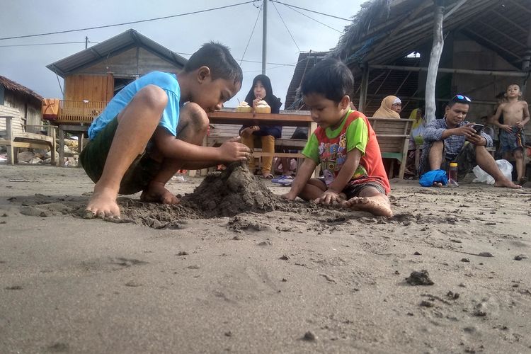 Anak bermain pasir di Pantai Ujong Blang, Kota Lhokseumawe, Aceh, Sabtu (8/6/2019)