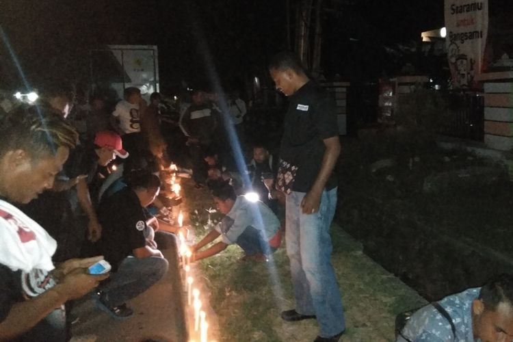 Para relawan Jokowi, sedang menyalakan lilin di depan Kantor KPU NTT, Minggu (21/4/2019) malam
