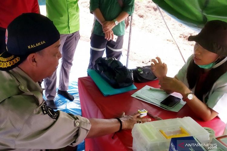 dr Sri Rizki Malau tengah memeriksa kesehatan anggota Satgas yang tengah memadamkan kebakaran hutan dan lahan di pedalaman Indragiri Hilir, Riau, Selasa (6/8/2019)
