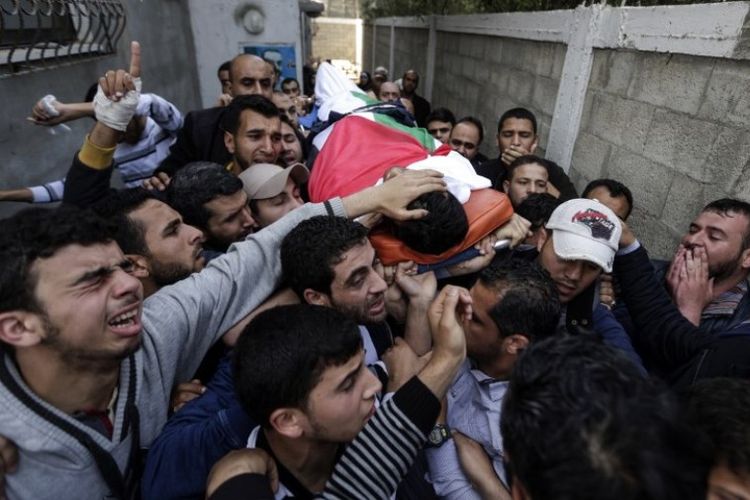 Para pelayat dan wartawan membawa jenazah wartawan Palestina Yasser Murtaja di Gaza City, Sabtu (7/4/2018). (AFP/Mahmud Hams)