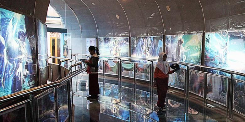Pengunjung menyaksikan gambar-gambar seputar dunia astronomi di salah satu sudut Planetarium yang terletak di kompleks Taman Ismail Marzuki, Cikini, Jakarta Pusat, Rabu (14/1/2015). Planetarium menjadi salah satu obyek wisata edukasi andalan di Jakarta.