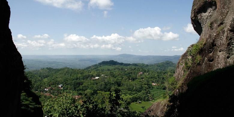 Pemandangan Kota Yogyakarta dari celah dua batu raksasa di kawasan wisata Gunung Api Purba Nglanggeran, Gunungkidul, DI Yogyakarta.