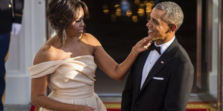 Michelle Obama merapikan dasi Barack Obama di acara Nordic Summit. 