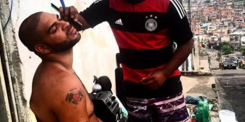 Adriano Leite Ribeiro tengah mencukur janggut di daerah Favela, Rio De Janeiro, Brasil.