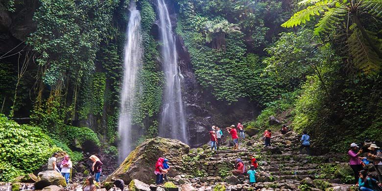 Wisatawan sedang menikmati suasana di bawah aliran Air Terjun Jumog