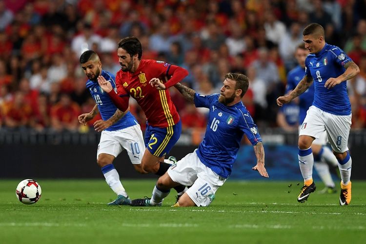 Gelandang timnas Spanyol, Isco (2 dari kiri), berebut bola dengan penyerang Italia, Lorenzo Insigne (kiri) dan gelandang Italia Daniele De Rossi (2 dari kanan). Sementar itu gelandang lainnya dari Italia, Marco Verratti, mengamati aksi rekannya tersebut dalam pertandingan kualifikasi Piala Dunia 2018 di Santiago Bernabeu, 2 September 2017.
