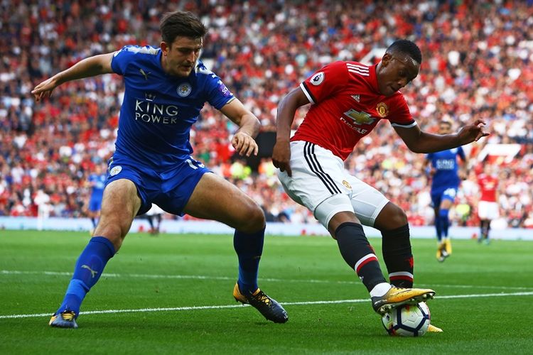 Bek Leicester City, Harry Maguire (kiri), berebut bola dengan striker Manchester United, Anthony Martial, dalam pertandingan Premier League di Old Trafford, Manchester, 26 Agustus 2017.
