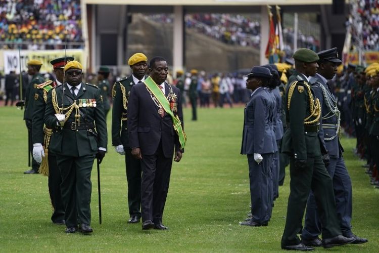Presiden Zimbabwe Emmerson Mnangagwa berjalan didampingi para pengawal setelah membacakan sumpahnya di stadion nasional Harare, Jumat (24/11/2017).