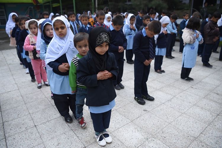 Para murid berbaris untuk mengawali hari pertama masuk sekolah, di sebuah sekolah swasta di Kabul, Afghanistan, Sabtu (24/3/2018). (AFP/Wakil Kohsar)