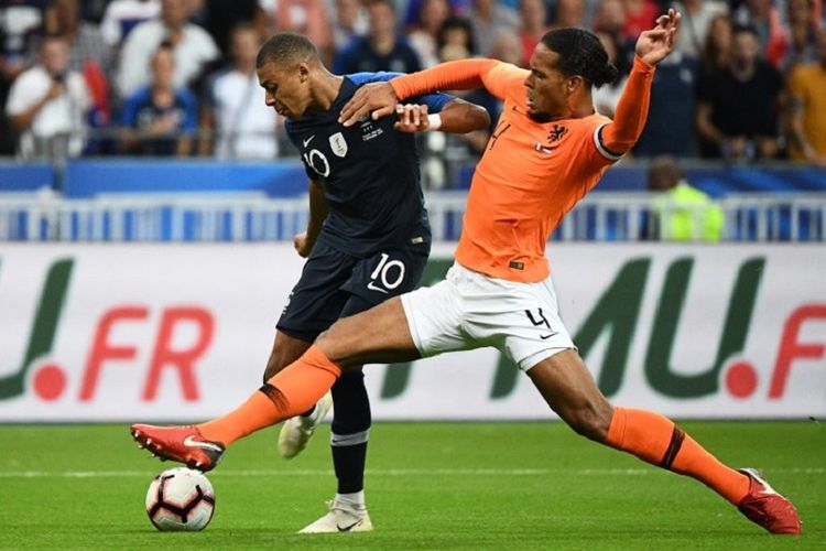 Kylian Mbappe dihalang-halangi oleh Virgil van Dijk ketika akan menendang bola pada pertandingan Perancis vs Belanda di Stade de France, 9 September 2018. 