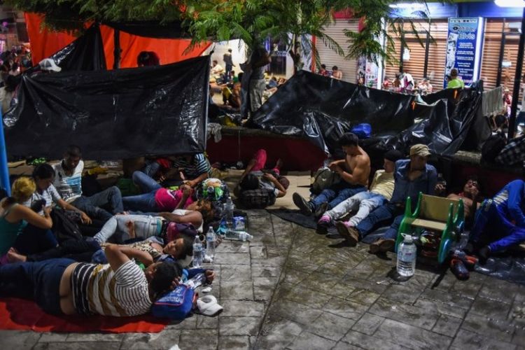 Warga dari Honduras tergabung dalam Karavan migran menuju ke Amerika Serikat sedang beristirahat di Huixtla, negara bagian Chiapas, Meksiko, Senin (22/10/2018). (AFP/Johan Ordonez)