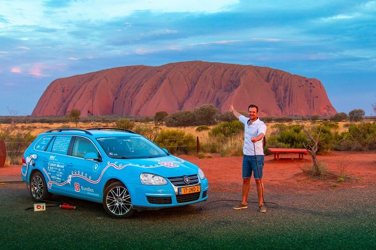 Dalam foto yang diambil pada 31 Desember 2018 memperlihatkan, warga Belanda Wiebe Wakker berpose di Uluru, Northern Territory, Australia dengan mobil listrik miliknya The Blue Bandit dalam perjalanan keliling dunianya.