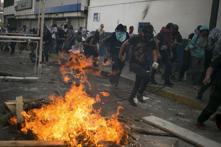 Bentrokan terjadi pada Hari Buruh atau May Day di Caracas, Venezuela, Rabu (1/5/2019). (AFP/CRISTIAN HERNANDEZ)