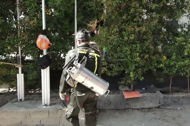 Seorang petugas Kementerian Kesehatan melakukan penyemprotan di Posko Basranas Petobo, Palu, Sulawesi Tengah guna mencegah penyebaran virus dari mayat. Rabu, (10/10/2018).