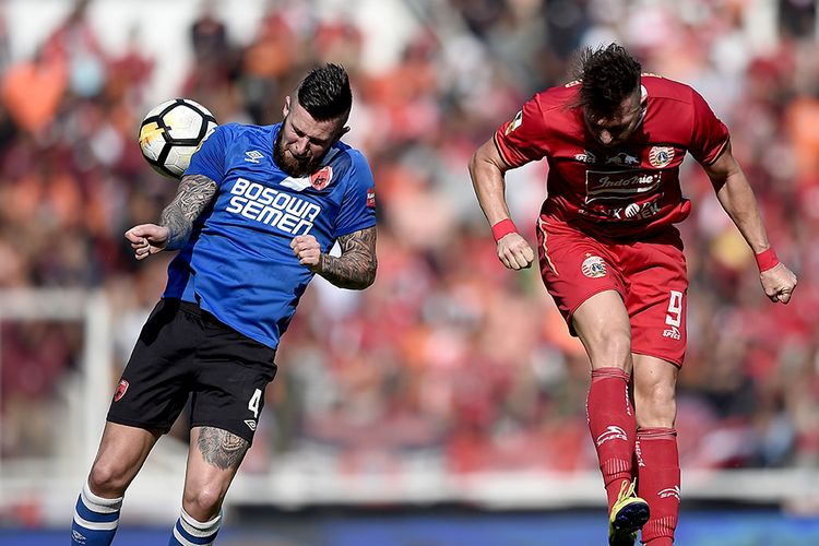 Pesepak bola Persija Jakarta Marko Simic (kanan) berusaha menyundul bola dengan dihadang pesepak bola PSM Makassar Aaron Michael Evans (kiri) dalam pertandingan Final Piala Indonesia 2018-2019 leg pertama di Stadion Utama Gelora Bung Karno (GBK), Senayan, Jakarta, Minggu (21/7/2019). Persija Jakarta menang atas PSM Makassar dengan skor 1-0.