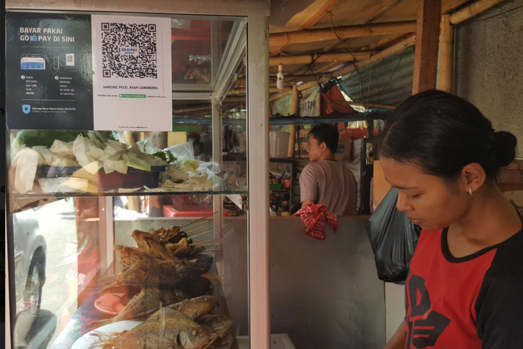 Fidia (25), pemilik warung Pecel Ayam Gondrong yang terletak di Kebon Sirih, Jakarta. Ia melayani pembayaran dengan Go-Pay menggunakan fitur QR Code.