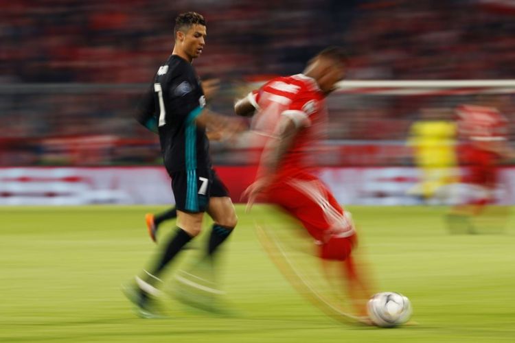 Cristiano Ronaldo mencoba merebut bola dari penguasaan Jerome Boateng saat Real Madrid menantang Bayern Muenchen pada laga semifinal Liga Champions di Allianz Arena, Rabu (25/4/2018).