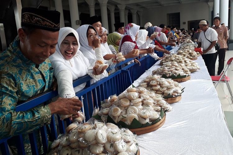 Warga berebut kue apem di Masjid Al Akbar Surabaya, Jumat (3/4/2019)