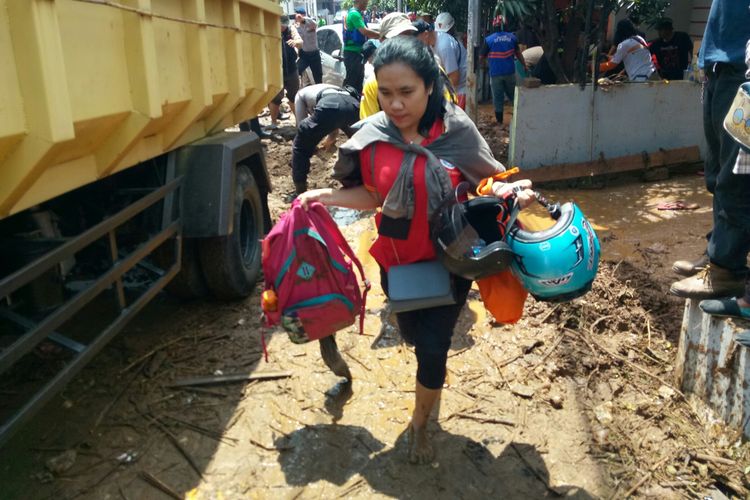 Tampak warga Komplek Pasir Jatiendah, Dusun Pasir Jati, Desa Jatiendah, Kecamatan Cilengkrang, Kabupaten Bandung tengah mengevakuasi diri ke tempat yang lebih aman pasca banjir bandang akibat jebolnya penahan sungai Cinambo Bandung.