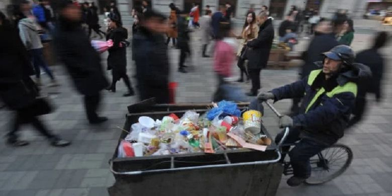 Zhao, seorang penyapu jalan di China ketika membawa gerobak berisi sampah.