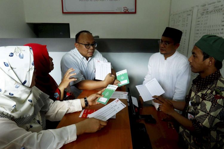 Deputi Komisioner Manajemen Strategis dan Logistik Otoritas Jasa Keuangan Anto Prabowo (tengah) dan Direktur Penelitian, Pengembangan, Pengaturan, dan Perizinan Perbankan Syariah Deden Firman Hendarsyah (dua kiri), mengamati kegiatan di Bank Wakaf Mikro, Pesantren Al-Munawwir, Krapyak, Bantul, DI Yogyakarta, Sabtu (5/5/2018). Bank Wakaf Mikro merupakan komitmen  OJK bersama pemerintah untuk terus memperluas penyediaan akses keuangan masyarakat, khususnya bagi masyarakat menengah dan kecil.