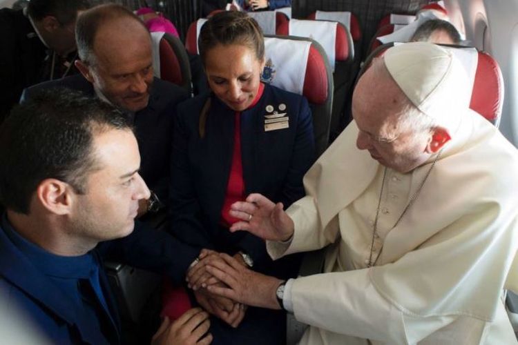 Paus Fransiskus memberkati pasangan Paula Podest (39) dan Carlos Ciuffadri (41)  dalam sebuah upacara pernikahan di tengah penerbangan, di Chile, Kamis (18/1/2018). (LOsservatore Romano Vatican Media via ABC)