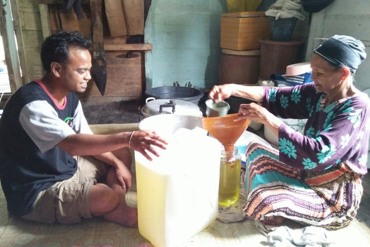 Sumayati melayani pembeli minyak kelapa olahan rumah tangganya, di Desa Sabuai, Kecamatan Kumai, Kabupaten Kotawaringin Barat