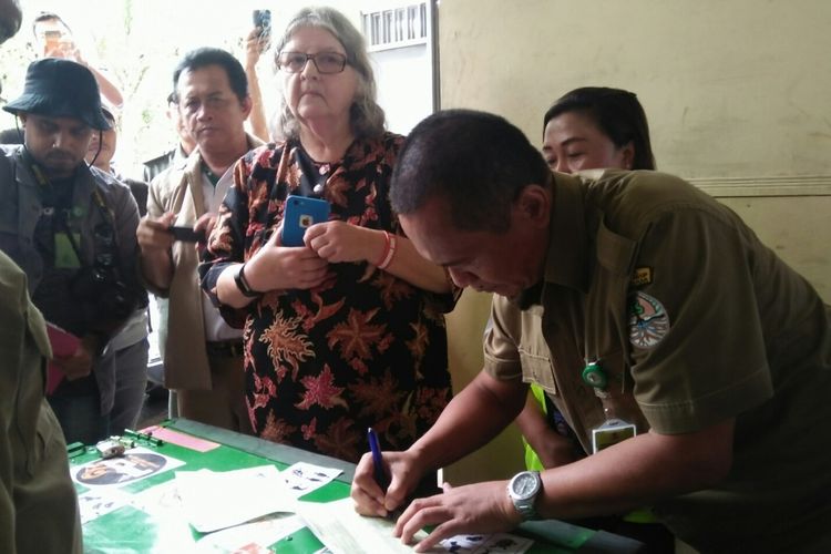 Adib Gunawan, Kepala Balai Konservasi Sumber Daya Alam (BKSDA) Kalimantan Tengah, menandatangani berita acara penyerahan orangutan Kalimantan, yang bernama Jono, kepada Birute Marry Galdikas, dari Orangutan Foundation International (OFI), Senin (23/4/2018)