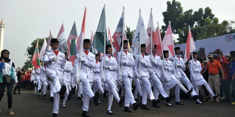 Paskibra membawa bendera negara peserta Asian Para Games dalam parade Momo Asian Para Games 2018 di Monas, Jakarta Pusat, Minggu (23/9/2018).