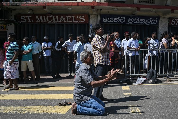 Warga Sri Lanka berdoa di luar gereja St Anthony di Kolombo pada Senin (22/4/2019), sehari seteah tempat ibadah itu diguncang serangan bom. 