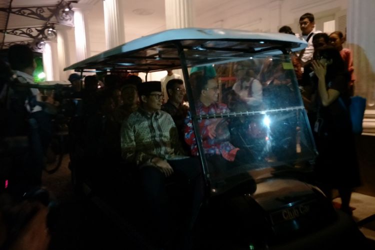 Gubernur DKI Jakarta Anies Baswedan dan Wakil Gubernur DKI Jakarta Sandiaga Uno mengendarai golf car  menuju acara nikah massal, Minggu (31/12/2017).