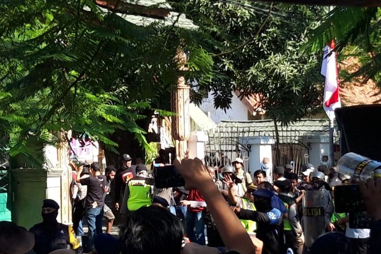 Sejumlah polisi menggunakan perisai mendobrak dan menjebol pintu pagar Asrama Papua Surabaya di Jalan Kalasan, Surabaya, Jawa Timur, Sabtu (17/8/2019).