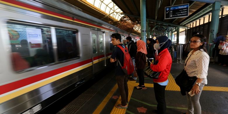 Sejumlah penumpang kereta listrik (KRL) Jabodetabek menunggu di garis batas antrean berwarna hijau di Stasiun Juanda, Jakarta Pusat, Rabu (9/8/2017). Garis batas antrean ini dibuat agar arus keluar masuk penumpang lebih teratur dan diharapkan dapat menghindari aksi saling mendorong sesama penumpang KRL.