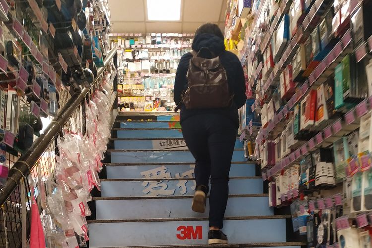 Konsumen berjalan menuju lantai dua sebuah toko ritel serba ada di Taipei, Taiwan, Senin (18/2/2019).